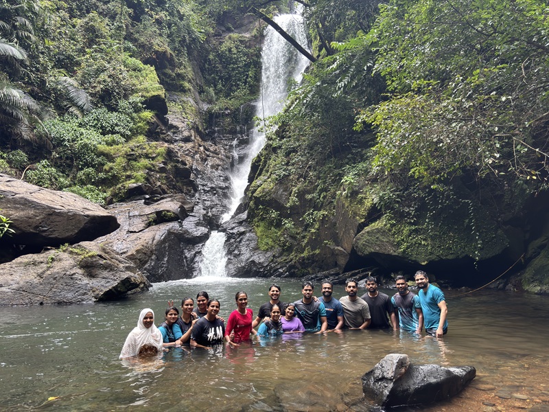 CodeMax team enjoying a monsoon waterfall trek in the Goa countryside